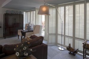 Large tracked shutters over garden patio doors