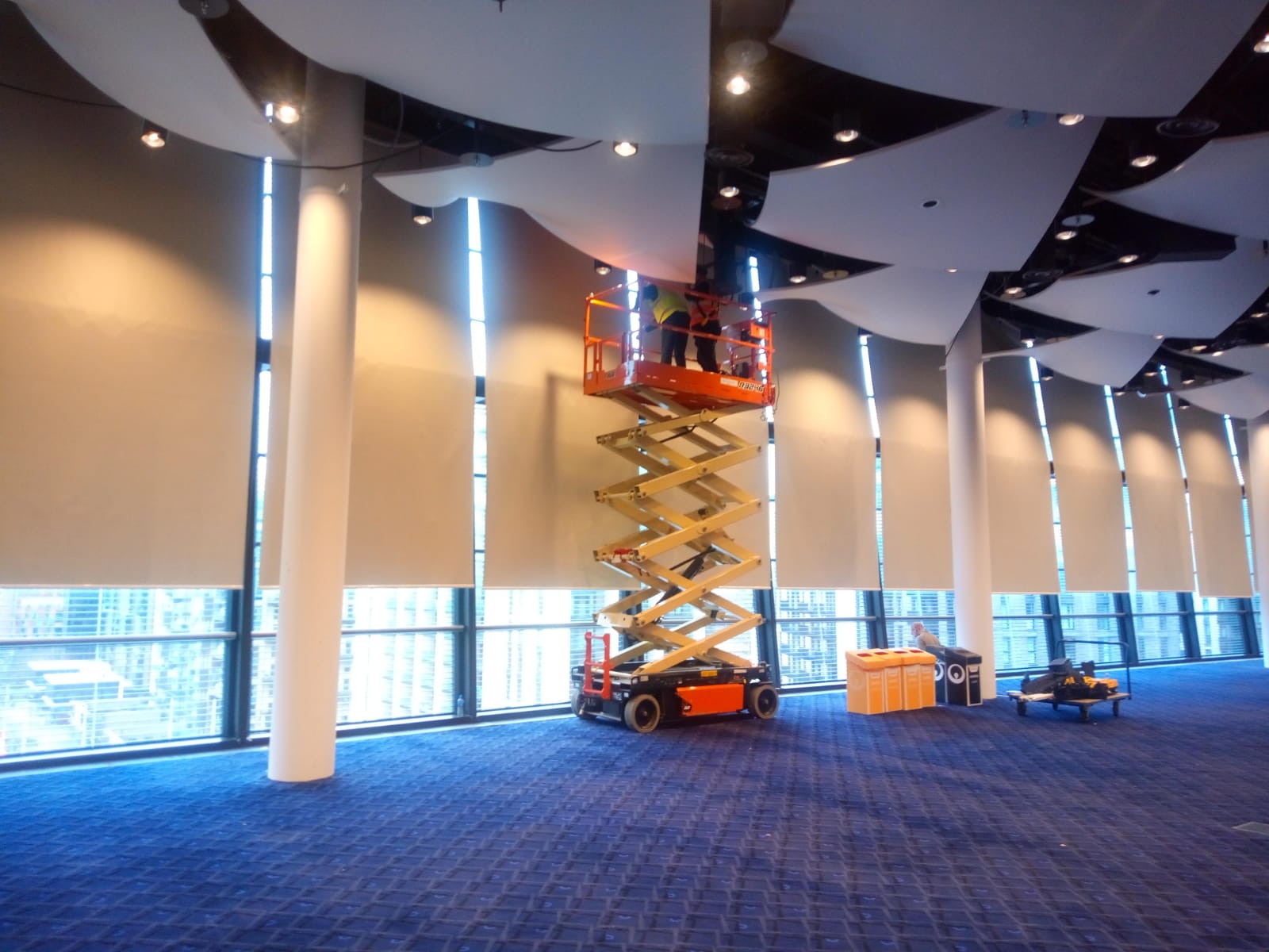 Wembley Stadium installation of large motorised roller blinds using a scissor lift